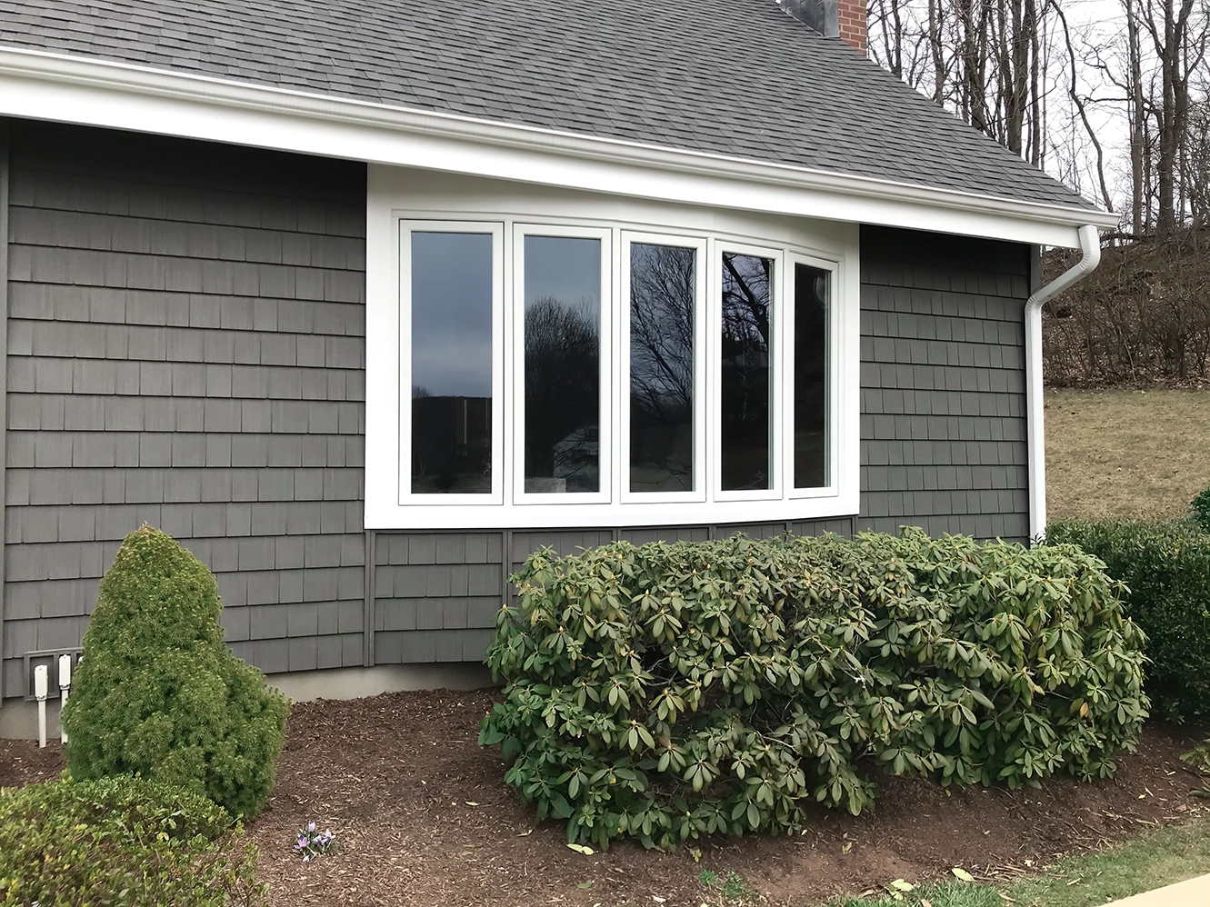 Bow window on a house with cedar impressions perfect shingles vinyl siding